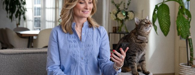 Woman on sofa with cat - pet tracker smart home device Integration